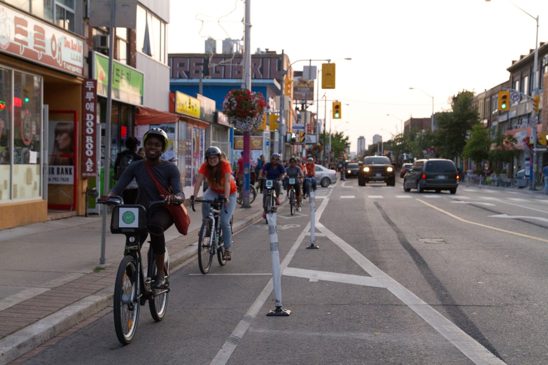 People cycling in a protected Toronto bike lane